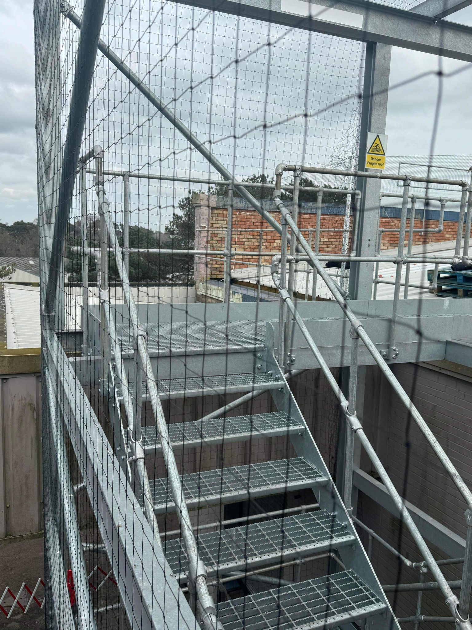 Bird-proofing netting installed along the side of a building to prevent pigeons from roosting.